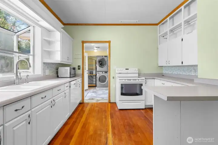 Light and bright kitchen with original hardwood floors. Light and bright kitchen with original hardwood floors.