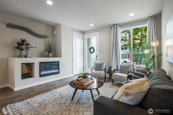 High ceilings and open layout- electric fireplace and large picture window. High ceilings and open layout- electric fireplace and large picture window.
