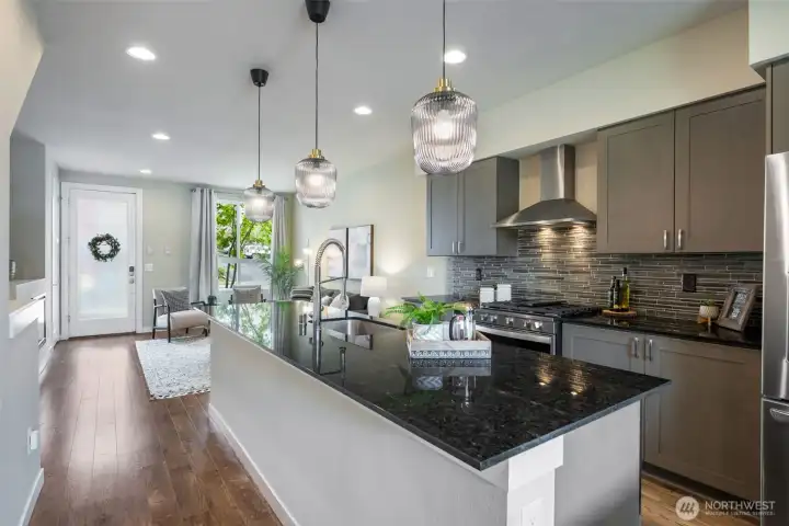Quartz counters and stainless appliances. Tile backsplash, gas cooking with full vented range. Quartz counters and stainless appliances. Tile backsplash, gas cooking with full vented range.