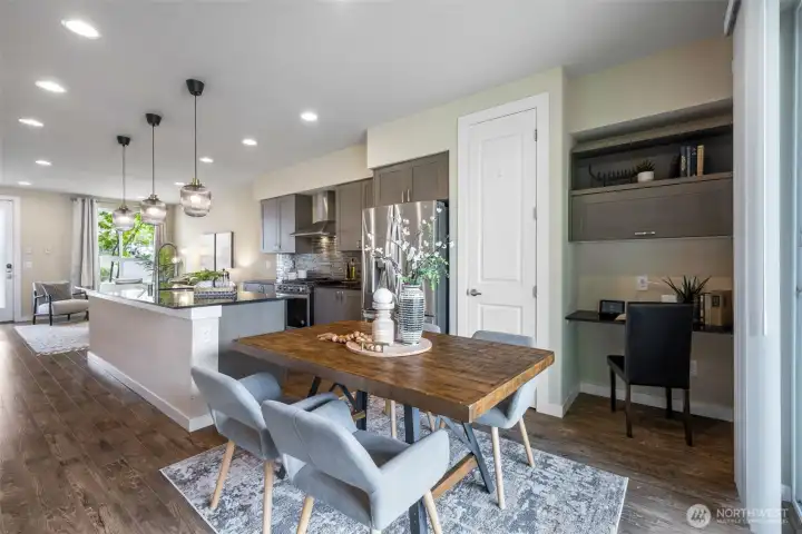 Full dining space- pantry in the background and an office nook. Full dining space- pantry in the background and an office nook.