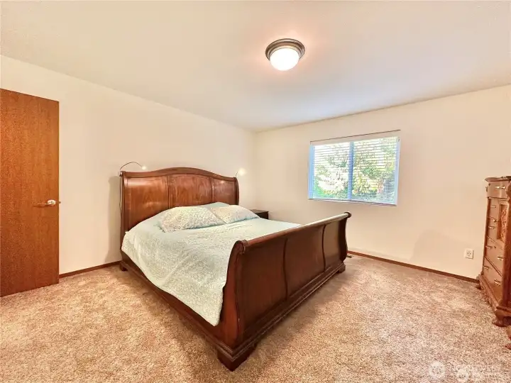 Man floor primary bedroom in main home.