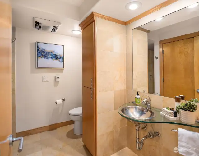 The guest bath just off the entry is efficient in it's use of space with shower and the utility closet.