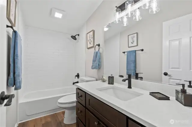 Main Full Bath w/Custom Tiled Shower and New Vanity w/Quartz Counter and Backsplash.