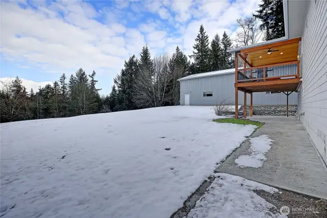 Another view of the large covered deck and patio space from the lower level.