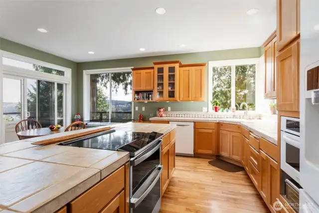 This enormous kitchen anchors the open gathering space, with large sliders leading out to the deck.