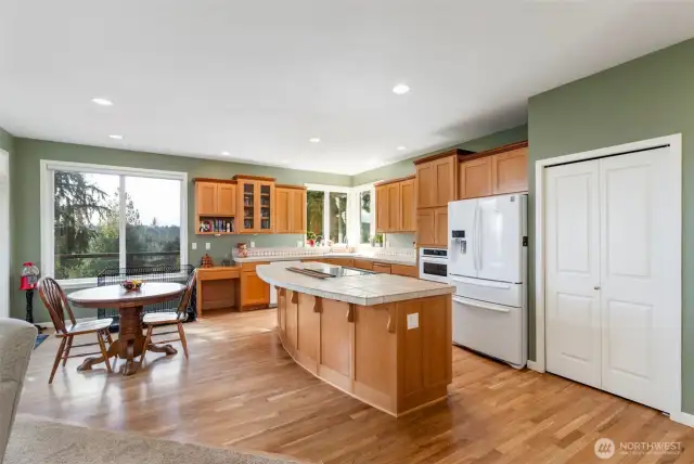 More large windows, solid wood cabinets and newer appliances create this chef's kitchen. Huge double-door pantry is such a bonus!