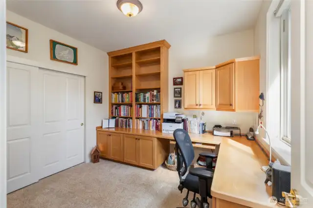 Off the living area, this roomy office provides plenty of built-in storage and work space.