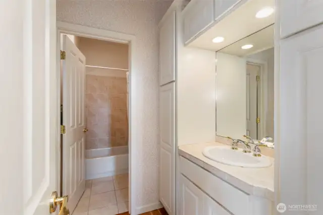 The main floor full bath is convenient to the gathering area and has ample storage space.