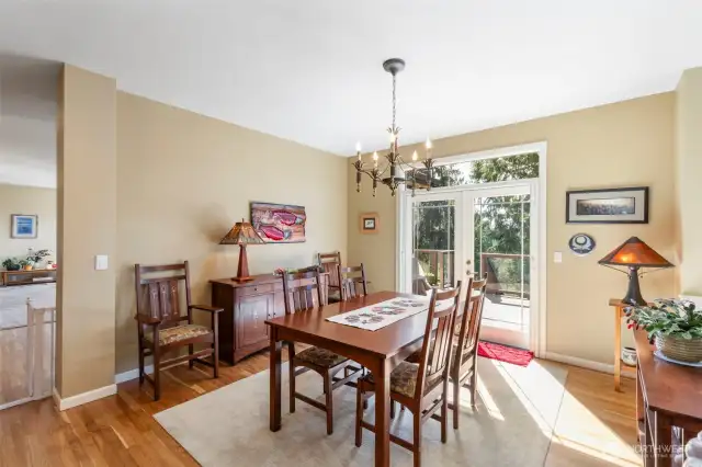 This generous dining room is perfect for gathering and entertaining! Pretty french doors bring the outside in and provide handy access to the deck.