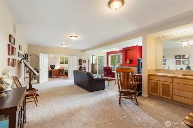 Moving downstairs, this enormous family room and recreation space is big enough for the largest gatherings. A wet bar and serving area makes entertaining a breeze. The slider at the end accesses the back yard.