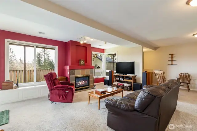 Huge windows keep the space light and bright, the gas fireplace keeps it cozy.