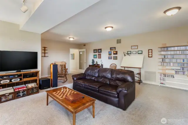 The recreation room ejoys plenty of space for all your activities. The door in the back accesses the stairs and 2nd and 3rd bedrooms.