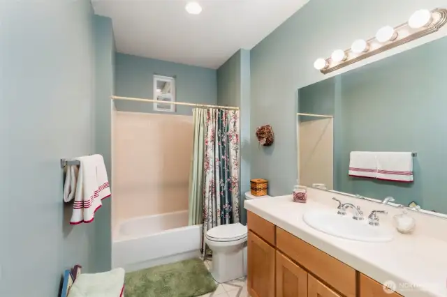 The downstairs full bath is positioned next to the bedrooms for convenience and handy access.