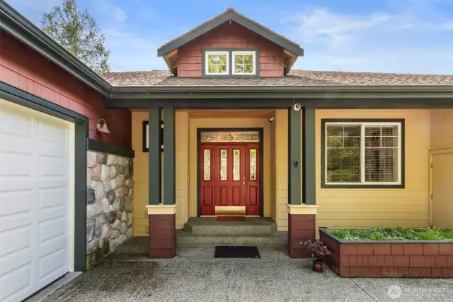 This charming covered entry is bright and welcoming.