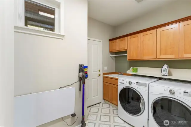 On the other side of the entry, this oversized laundry/mud room provides access to the garage.