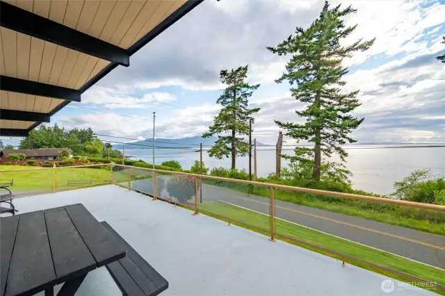 The huge deck (partially covered making it an all-season hang) looks out over the Salish Sea toward Orcas Island and is mere steps from the beach. Gorgeous sunset views over Maria and Sucia Islands,