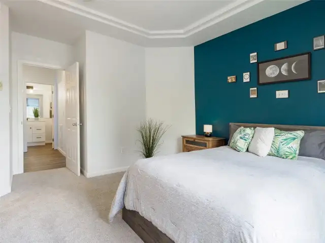 Tray ceilings and color pop wall for a fresh perspective.