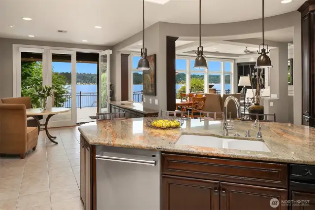 The casual dining nook flows seamlessly to the covered outdoor entertainment deck with overhead radiant heating.