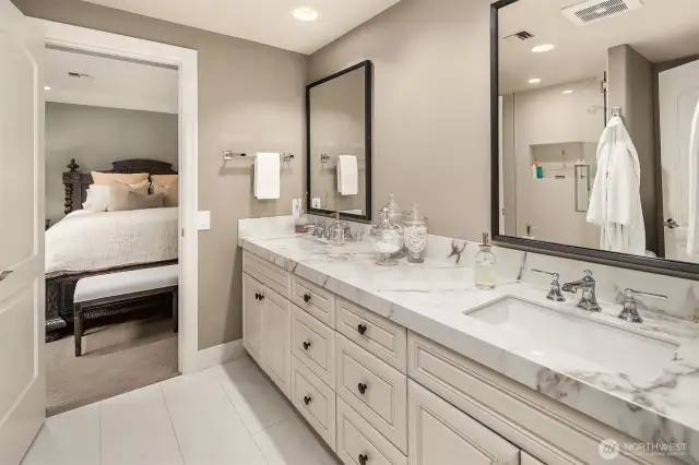 Shared dual vanity 3/4 disigner bathroom between the 2 guest chambers on the lower level.
