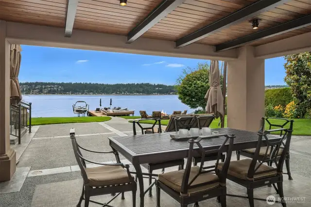 Steel beams with wood insets, designer lighting and pressed concrete patio for the ultimate outdoor lakefront dining/living room!