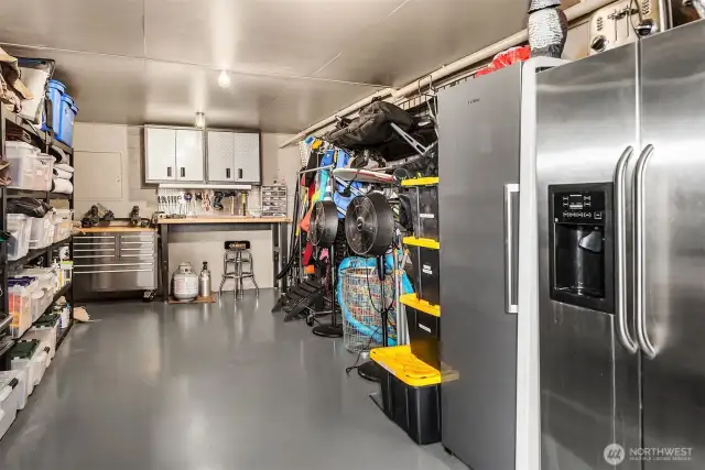 Just behind the outdoor kitchen, behold a massive storage room with full size freezer, refrigerator and tons of storage for water sports equipment and outdoor furniture storage.
