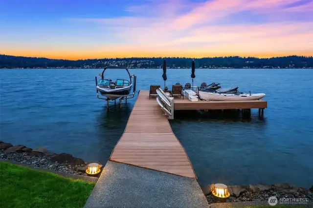 Massive Trex deck dock with lighting, Sunstream boat lift, dual Basta watercraft lifts, swim ladder and enough room to host a dinner at the end of the dock at sunset!!