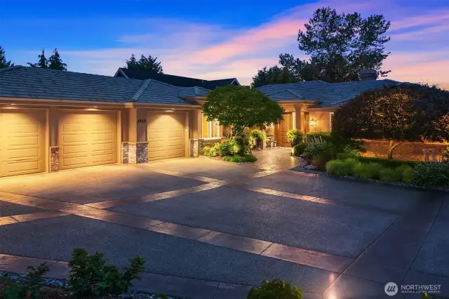 3 car garage with pressed concrete driveway and lovely mature landscaping.