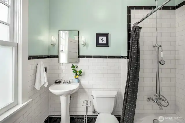 The newer main floor bathroom is lovely and the style is true to the rest of the home. So much wow factor everywhere you look here!