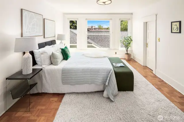 Southern light and parquet flooring in this large bedroom.
