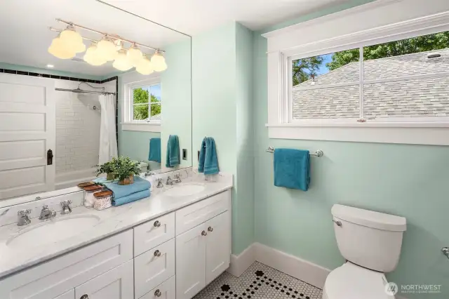 The top floor bathroom has been fully remodeled (studs out) and has double sinks, custom lighting and period details.