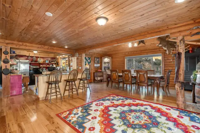 Open floor plan with beautiful hardwood floors and warm wood interior