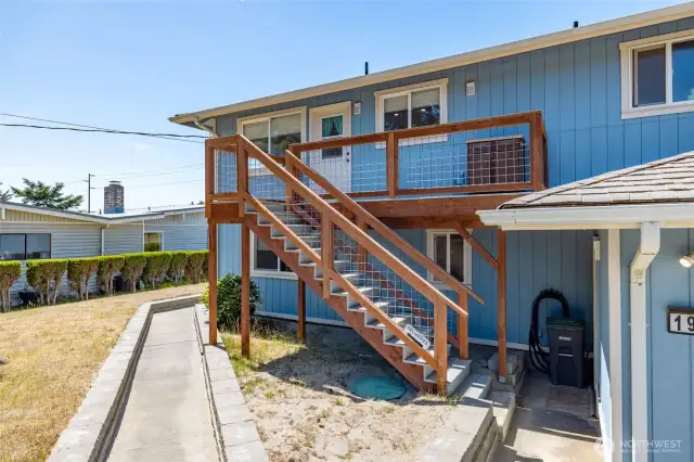 Back entry with small landing area. Walkway around to front of home.