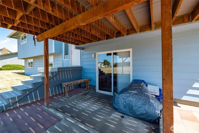 Area under deck with slider into lower level.