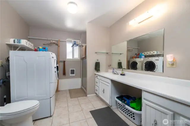 3/4 bath with laundry facilities and storage on