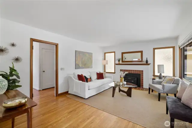 Hardwood floors run throughout most of the main level. The living room has a fireplace with a wood-burning insert and mahogany mantel which matches the original mahogany trim.