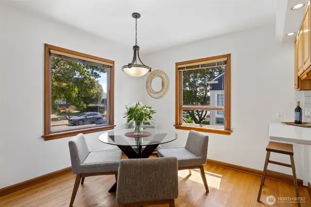 In addition to space for a dining table, there is also a small counter which opens to the kitchen. It's a perfect spot for friends to sit while talking with the cook!