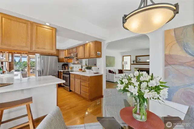 View from dining room toward kitchen. To the left of the refrigerator is the study nook, stairs to lower level, and entrance to the family room.
