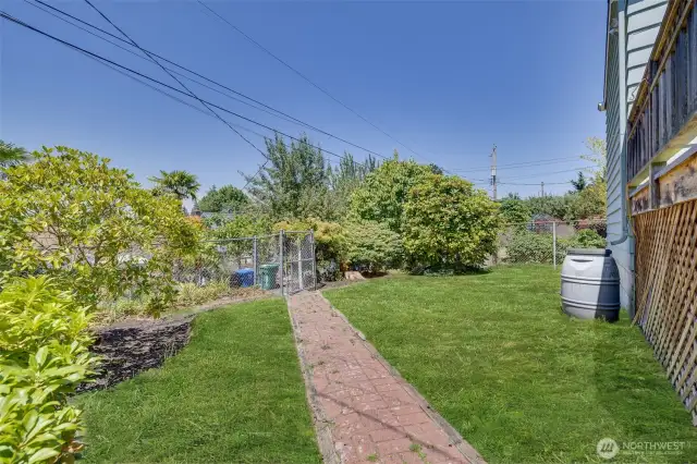 Fully-fenced and level back yard with mature landscaping.