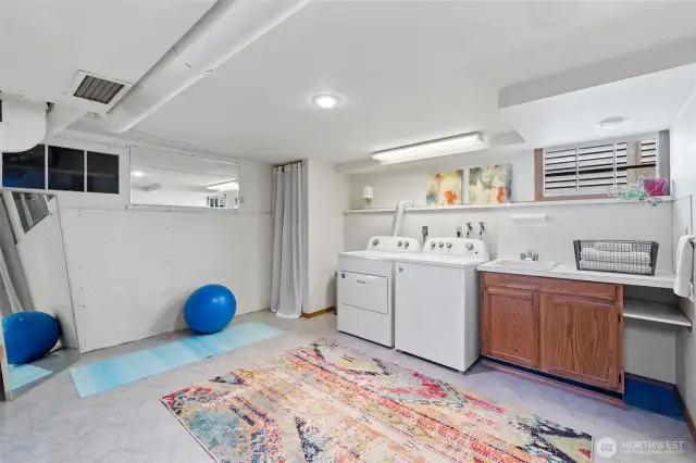 Bright and open laundry/flex space greets you upon entering the lower level of the home.