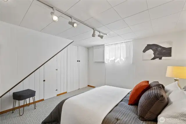 Lower level bedroom with built-in storage. Window may not be conforming size/height.