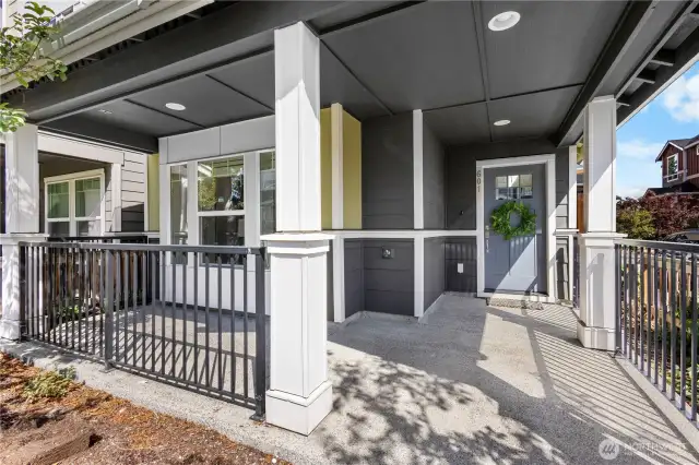 A covered, well-lit front porch welcomes you home.