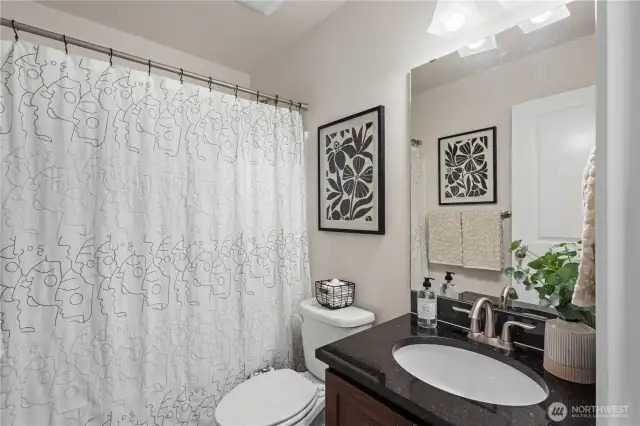 Full bath off the hallway, right by the second bedroom.