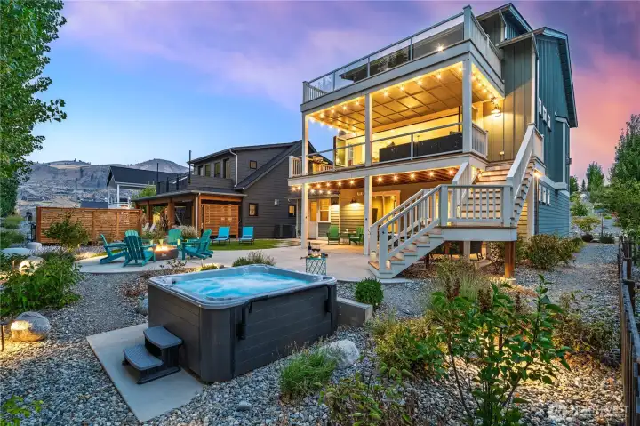 Exterior twilight view of home and outdoor living area with private spa.