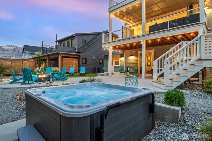 Exterior twilight view of private spa and outdoor living area.