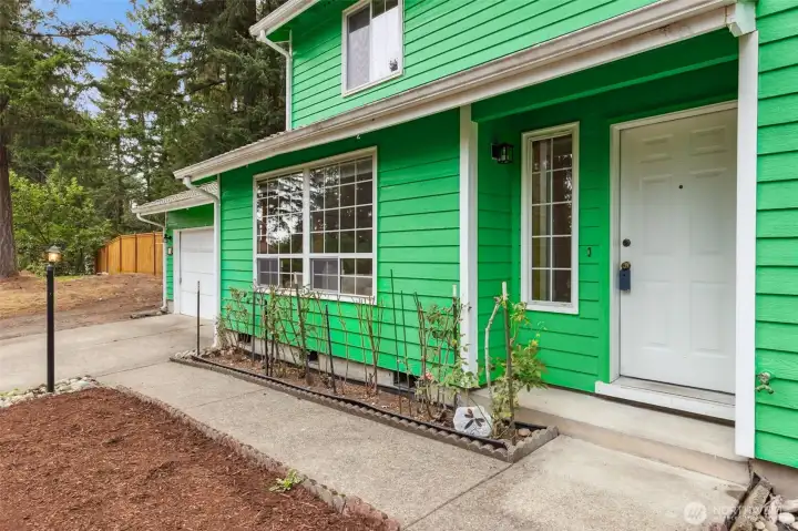 Welcoming front entry at 513 Hidden Forest Dr SE, Olympia — featuring a covered porch, large picture windows, and fresh exterior paint. Surrounded by evergreens and set in a quiet cul-de-sac community, this home offers a peaceful Pacific Northwest feel right from the front door. No HOA!