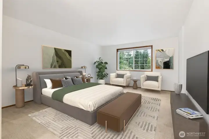 Expansive primary bedroom with plenty of space for a full seating area, large windows overlooking the trees, and a relaxing, retreat-like atmosphere.