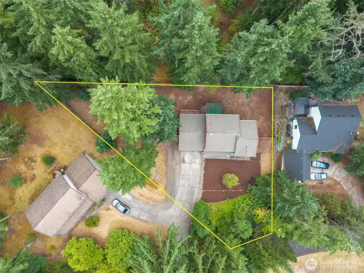 Surrounded by towering evergreens and nestled on a generous lot, this home offers privacy, space, and a peaceful natural setting. The bird’s-eye view highlights the expansive yard, ample parking, and comfortable separation from neighboring homes—an ideal retreat with room to grow, relax, and enjoy the Pacific Northwest landscape. Driveway easement.