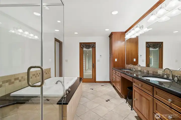 Glass enclosed shower in primary.