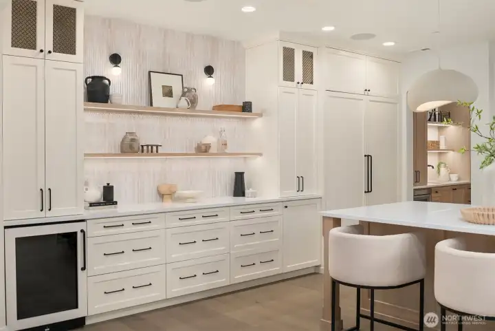 Custom cabinetry wall featuring a built-in, panel-ready refrigerator, open shelving, and integrated storage for a polished, uninterrupted kitchen aesthetic.