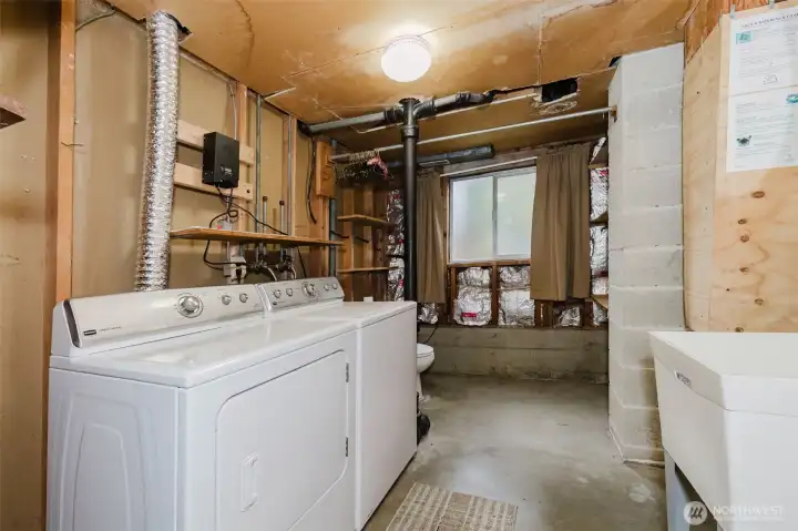 Laundry room with an additional toilet